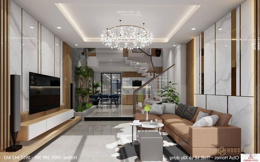 Phòng khách nhiều ánh sáng nhờ cửa chính làm bằng kính trong suốt