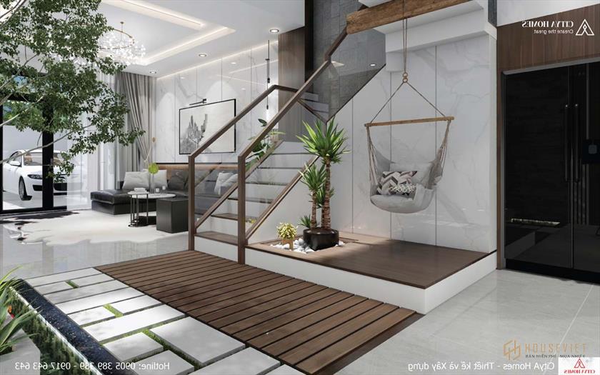 Góc khuất của cầu thang được tận dụng làm tiểu cảnh kết hợp với ghế mây thư giãn cho gia chủ