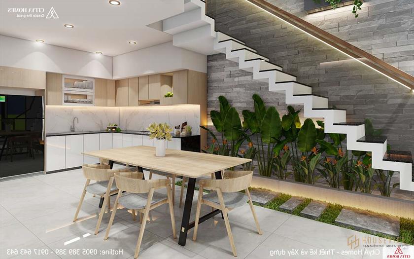 Góc gầm cầu thang có cây cỏ xanh mướt khiến không gian trở nên êm đềm